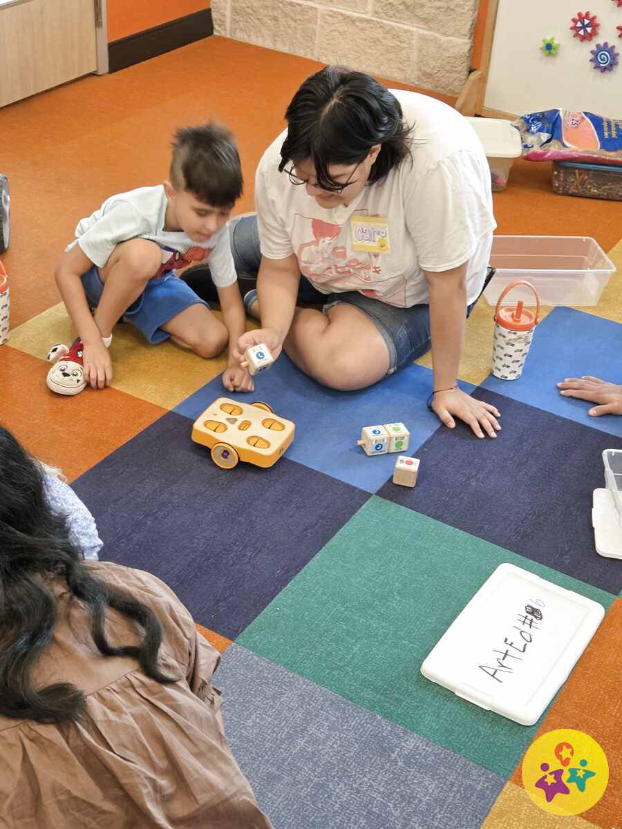 Carolina facilitating a robotics activity with a child