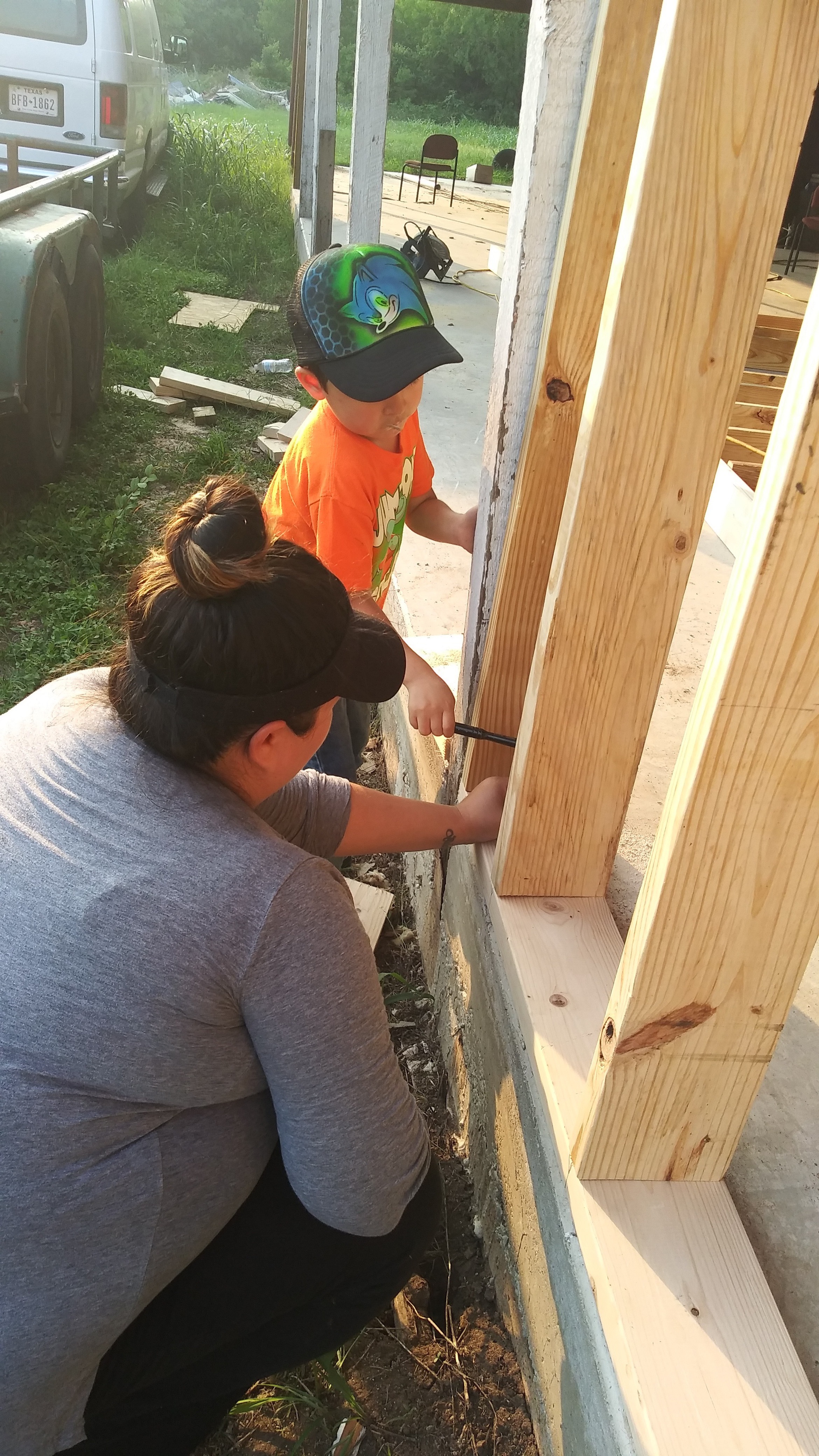 Becky and a child working together on a building project