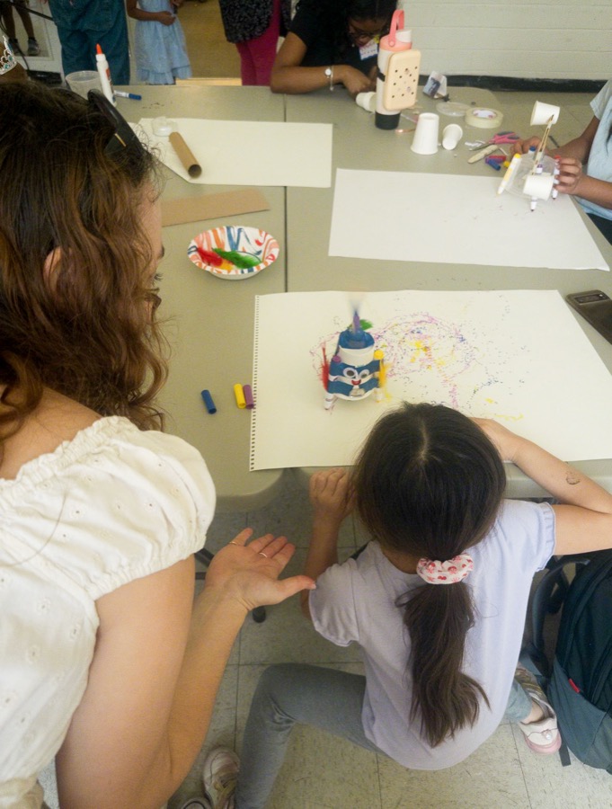McKenna facilitating an art activity at a table