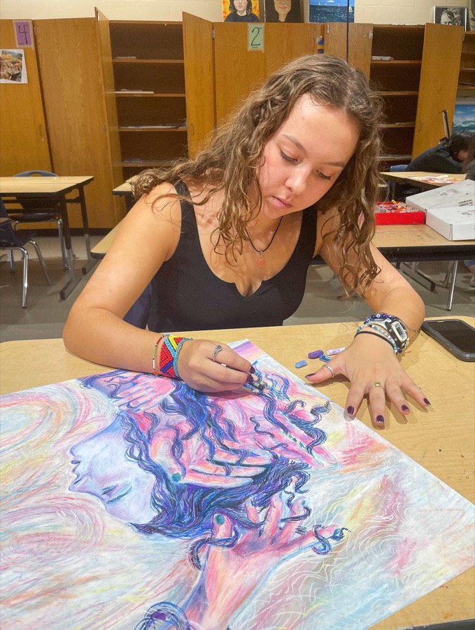 McKenna working on a pastel drawing in the art studio