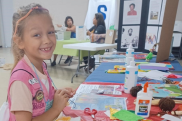 A child working on a craft at a Centro ArtSpace table